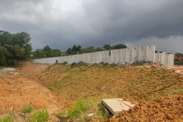 A retaining wall built along a slope, providing structural protection and preventing soil erosion.