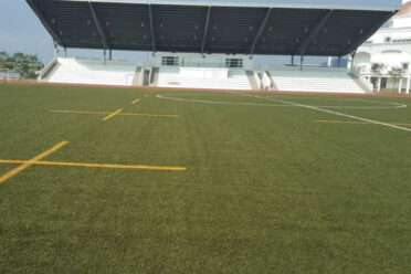 Close-up of a well-maintained soccer field with vibrant green turf and clear white field markings, perfect for professional and recreational matches.